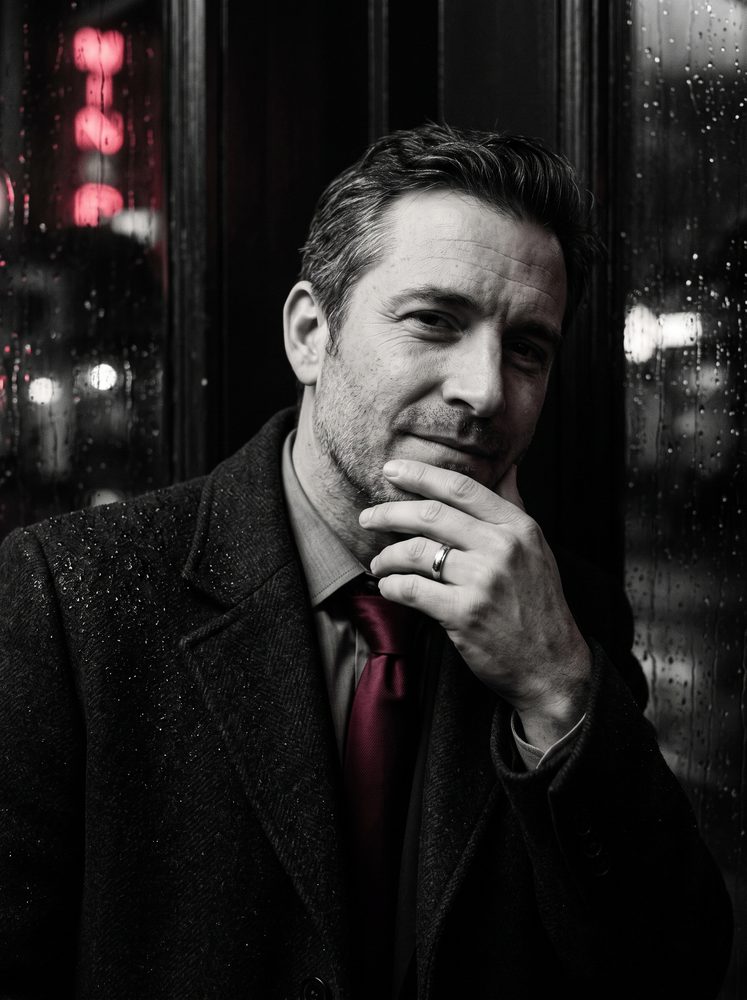 Portrait of a man in a coat wearing a wedding ring